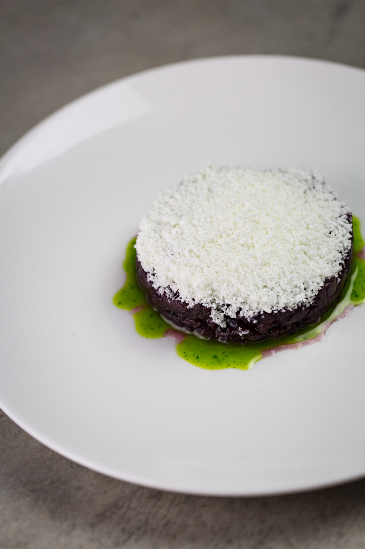 Venison tartare with herb oil and aged cheese